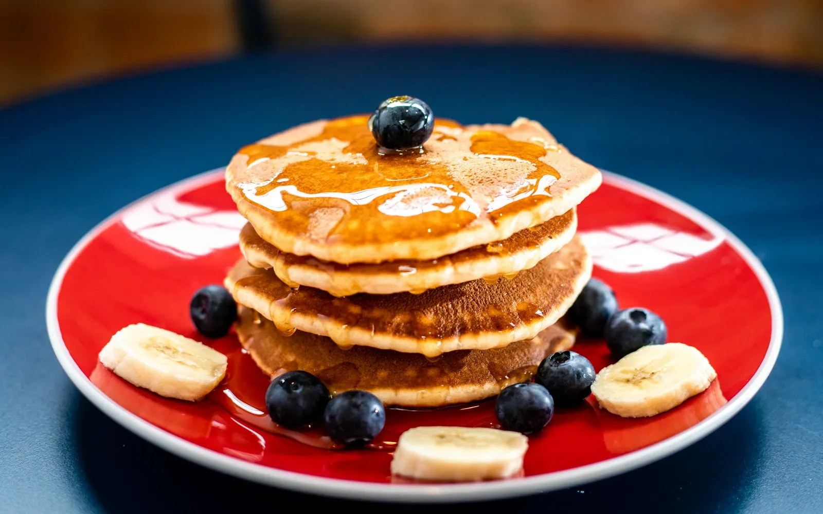 A stack of pancakes with butter and syrup