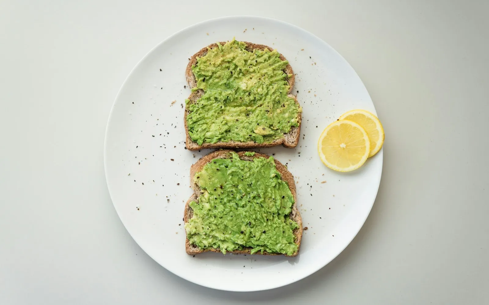 Avocado toast topped with seeds and herbs